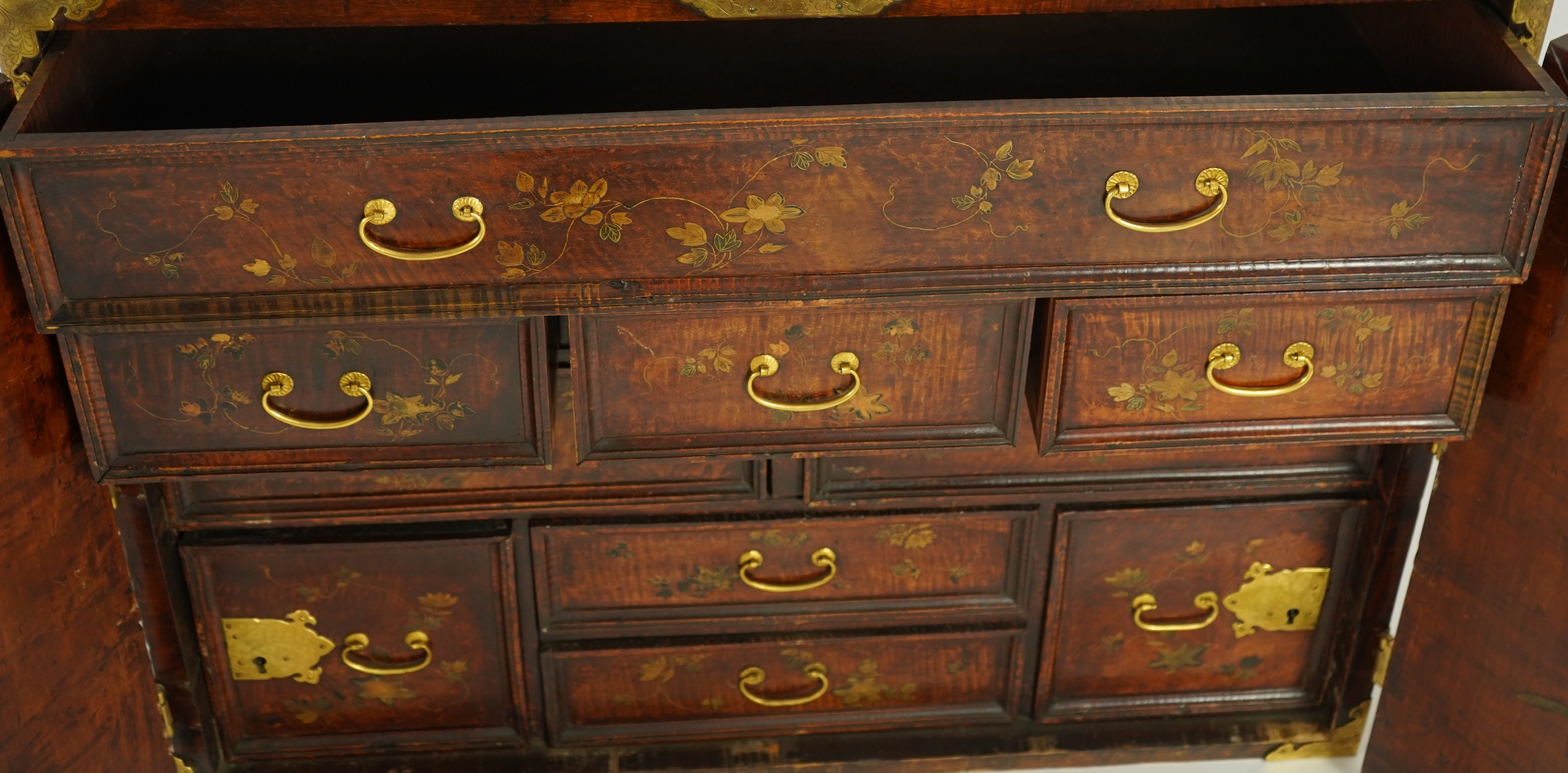 A Japanese mulberry wood, hiromaki-e lacquer and gilt copper mounted cabinet, c.1680-1700